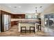 Spacious kitchen features dark wood cabinetry, stainless steel appliances and large island at 6647 Montezuma Castle Ln, North Las Vegas, NV 89084