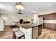 Open kitchen and living area, featuring a granite island, stainless steel appliances, and wood-style flooring at 6647 Montezuma Castle Ln, North Las Vegas, NV 89084