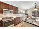 Spacious kitchen with stainless steel appliances, dark wood cabinets, and modern finishes at 6647 Montezuma Castle Ln, North Las Vegas, NV 89084