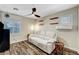 Relaxing living room with a comfortable sofa, modern lighting, and window shutters for privacy and style at 6647 Montezuma Castle Ln, North Las Vegas, NV 89084