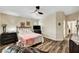 Cozy bedroom featuring wood-look flooring, ceiling fan, and neutral decor, offering a relaxing and inviting space at 6647 Montezuma Castle Ln, North Las Vegas, NV 89084