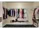 Spacious walk-in closet with ample storage, including hanging racks and shelves for shoes and accessories at 6647 Montezuma Castle Ln, North Las Vegas, NV 89084
