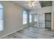 This bedroom features wood-look flooring, arched windows, and a ceiling fan at 700 Carnegie St # 122, Henderson, NV 89052