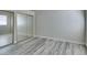 Bright bedroom features wood-look flooring and a mirrored closet at 700 Carnegie St # 122, Henderson, NV 89052