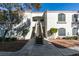 Condominium exterior with well-manicured landscaping, red tile roof and stairs to the second level at 700 Carnegie St # 122, Henderson, NV 89052