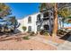 Condominium exterior featuring the building's design and surrounding landscape with sidewalk at 700 Carnegie St # 122, Henderson, NV 89052