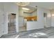 Bright kitchen with wooden cabinets, white appliances, and pass-through to living area at 700 Carnegie St # 122, Henderson, NV 89052