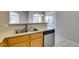 Kitchen with stainless dishwasher, wood cabinets and eat-in counter at 700 Carnegie St # 122, Henderson, NV 89052