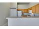 Efficient kitchen features wood cabinets and appliances, with closet space at 700 Carnegie St # 122, Henderson, NV 89052