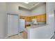 Functional kitchen with wood cabinets, white appliances and lots of storage at 700 Carnegie St # 122, Henderson, NV 89052