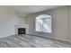 Living room featuring a fireplace, a large arched window, and gray wood-look flooring at 700 Carnegie St # 122, Henderson, NV 89052