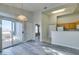 Bright living room features sliding glass doors to balcony and partial kitchen view at 700 Carnegie St # 122, Henderson, NV 89052