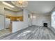 Open-concept living room features wood floors, fireplace, and adjacent kitchen at 700 Carnegie St # 122, Henderson, NV 89052