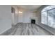 Bright living room with fireplace, gray floors, and large arched window at 700 Carnegie St # 122, Henderson, NV 89052