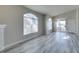 Bright living room with vaulted ceilings, arched windows, and gray wood-look flooring at 700 Carnegie St # 122, Henderson, NV 89052