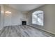 Living room showcasing a fireplace, large window, and gray wood-look flooring at 700 Carnegie St # 122, Henderson, NV 89052