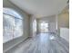 Living room featuring vaulted ceilings, arched windows, slider door and gray wood-look flooring at 700 Carnegie St # 122, Henderson, NV 89052