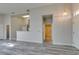 Open living space with bar top, gray wood-look floors, and entrance to bathroom at 700 Carnegie St # 122, Henderson, NV 89052