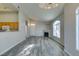 Open living area with kitchen view, fireplace, large window, and entry door at 700 Carnegie St # 122, Henderson, NV 89052