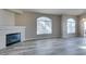 Living room with fireplace, arched windows, and stylish gray wood-look floors at 700 Carnegie St # 122, Henderson, NV 89052