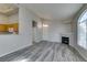 Open concept living area with grey floors, fireplace, and kitchen pass-through at 700 Carnegie St # 122, Henderson, NV 89052