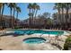 Inviting community pool and spa with surrounding lounge chairs for relaxing in the sun at 700 Carnegie St # 122, Henderson, NV 89052