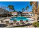 A luxurious community pool and lounge area surrounded by palm trees is perfect for relaxation at 700 Carnegie St # 122, Henderson, NV 89052