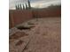 Wide backyard providing natural rock landscaping and a privacy wall, creating serene surroundings at 7112 Whitford St, Las Vegas, NV 89166