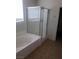 Bathroom with tile flooring, bathtub and shower combination with glass door and natural light at 7112 Whitford St, Las Vegas, NV 89166