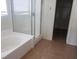 Bathroom featuring a tub with shower, and tile flooring at 7112 Whitford St, Las Vegas, NV 89166