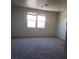 Well-lit bedroom with carpet flooring, offering a comfortable space to unwind and recharge at 7112 Whitford St, Las Vegas, NV 89166