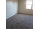 Bright bedroom featuring neutral walls and carpet and a sunny window offering natural light at 7112 Whitford St, Las Vegas, NV 89166