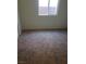 Simple carpeted bedroom featuring bright natural light and neutral paint ready for new decor at 7112 Whitford St, Las Vegas, NV 89166