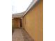View of front door and xeriscaped yard of single-story stucco home at 7112 Whitford St, Las Vegas, NV 89166