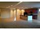 Open floor plan with modern kitchen and island with seating, seamlessly connecting to the living space at 7112 Whitford St, Las Vegas, NV 89166