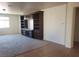 Bright living room with neutral walls, plush carpet, and custom built-in shelving at 7112 Whitford St, Las Vegas, NV 89166