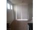 Inviting living room featuring tile flooring and bright, natural light from the sliding glass door at 7112 Whitford St, Las Vegas, NV 89166