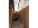 Narrow side yard with neutral paint and a large AC unit, ideal for utilities at 7112 Whitford St, Las Vegas, NV 89166