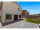 Cozy backyard features patio, artificial grass, and direct access to the home at 7432 Red Plumeria Ave, Las Vegas, NV 89113