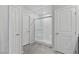 Bathroom with modern glass-enclosed shower and tiled floors, plus convenient access doors at 7432 Red Plumeria Ave, Las Vegas, NV 89113