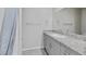 Bathroom vanity with granite countertop and framed mirror at 7432 Red Plumeria Ave, Las Vegas, NV 89113
