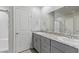 Bathroom featuring double sinks with granite countertop, and a glass-enclosed shower at 7432 Red Plumeria Ave, Las Vegas, NV 89113