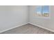 Bedroom with wood-look floors and natural light from the window at 7432 Red Plumeria Ave, Las Vegas, NV 89113