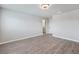 Bedroom has gray vinyl floors, light gray walls, white trim, and a modern light fixture at 7432 Red Plumeria Ave, Las Vegas, NV 89113