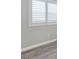 Bedroom features gray vinyl floors, light gray walls and white trim, with shuttered windows at 7432 Red Plumeria Ave, Las Vegas, NV 89113