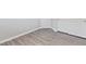 Bedroom with gray vinyl floors, complemented by white walls and baseboards, along with a mirrored closet door at 7432 Red Plumeria Ave, Las Vegas, NV 89113