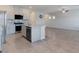 Modern kitchen showcasing granite countertops, stainless steel appliances, tile floors, and open floorplan at 7432 Red Plumeria Ave, Las Vegas, NV 89113