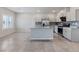 Bright, open kitchen features tile floors, gray cabinetry, stainless steel appliances, and granite countertops at 7432 Red Plumeria Ave, Las Vegas, NV 89113