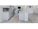 Well-lit kitchen boasts tile flooring, a center island, granite countertops, and stainless steel appliances at 7432 Red Plumeria Ave, Las Vegas, NV 89113