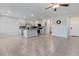 Open-concept kitchen with tile flooring, stainless steel appliances, granite countertops, and gray cabinets at 7432 Red Plumeria Ave, Las Vegas, NV 89113